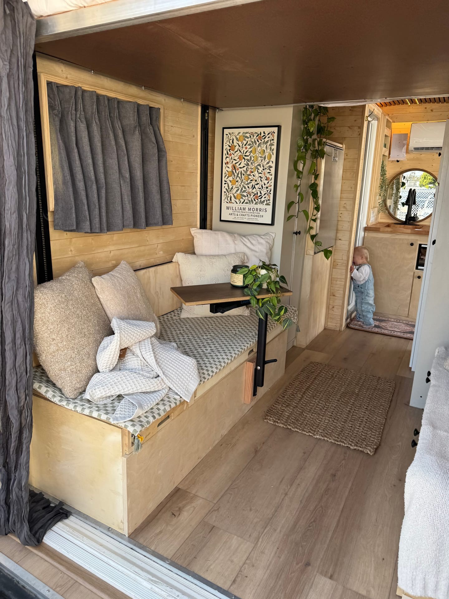 Wanderwell cargo trailer conversion — styled bed area with wood paneling